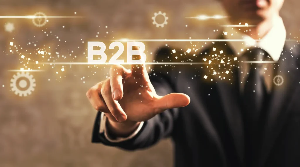 Executivo em terno apontando para o termo B2B em ambiente digital corporativo